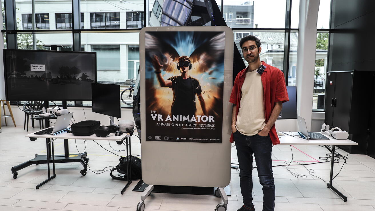 Man standing with a poster of VR animation
